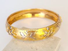 Stunning and exceptionally exquisite bangle bracelet of 18k solid gold. It combines yellow and white gold in a floral blossomy design which is artistically engraved with a 3 Dimensional highly ornamental filigree-like pattern and a diamond cut finish that gives the bracelet a very lustrous look. The outside length is 8 inches and width is 0.6 inches. The length of the inside of the bracelet is approximately 6.6 inches, which makes it approximately 17 cm. The diameter of the bracelet is 2.2 inche Ornamental Filigree, Wedding Fancy, 18k Gold Bangle, Fancy Gifts, Unique Gifts For Women, Gold Bangle Bracelet, Gold Bangle, Gold Floral, Art Wedding