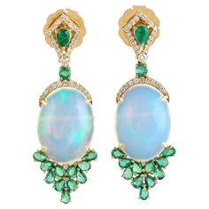 Cast in 14 karat gold. These earrings are handset in 12.48 carats Ethiopian opal, emerald and .34 carats of sparkling diamonds. FOLLOW MEGHNA JEWELS storefront to view the latest collection & exclusive pieces. Meghna Jewels is proudly rated as a Top Seller on 1stDibs with 5 star customer reviews. All items manufactured by us are handmade and can be customized or redesigned. Composition Size: 40X13MM Gold Weight(Gms)-6.347 Diamond Wt(Cts)-.34 Opal, Emerald Wt(Cts)-12.48 Fine Jewels, Opal Earrings, Gorgeous Jewelry, Top Seller, Opal Jewelry, Emerald Diamond, Sparkle Diamonds, Ethiopian Opal, Gemstone Earrings