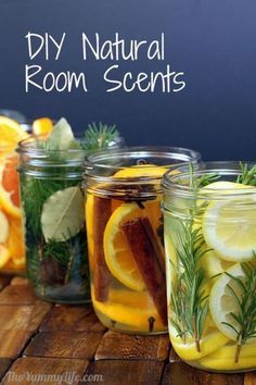 four jars filled with lemons, rosemary and other herbs on a table next to a chalkboard that says diy natural room scent