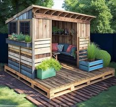 a small wooden shed sitting on top of a lush green field