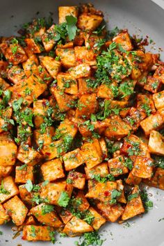 a white plate topped with tofu and parsley