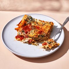 a slice of lasagna on a plate with a fork