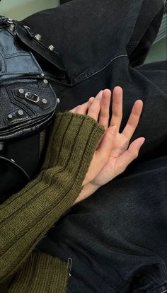 a woman's hand resting on her purse