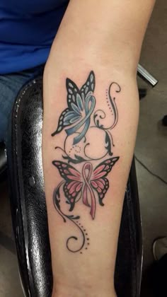 a woman with a butterfly tattoo on her arm