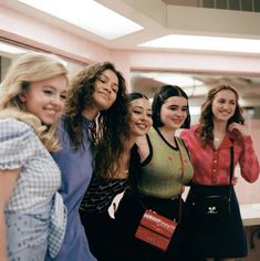 a group of young women standing next to each other