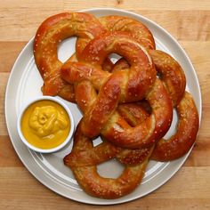 pretzels and mustard on a white plate