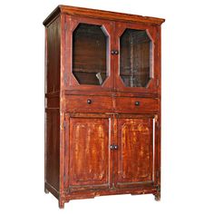 an old wooden cabinet with glass doors on the front and bottom shelves, isolated against a white background