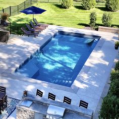 an above ground pool surrounded by patio furniture