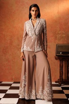 Sand drift padded blazer with floral, cutdana, pearl, sequin embroidery and geometric pattern texture. Paired with a flared pant, elevated with floral embroidery. Comes along with an inner padded bustier. - Aza Fashions Fitted Pant Set For Workwear And Festive Occasions, Fitted Long Sleeve Palazzo Set, Fitted Nehru Jacket With Chikankari Embroidery For Party, Fitted Palazzo Set For Workwear, Tailored Festive Sets For Reception, Elegant Formal Palazzo Set With Cutdana, Eid Workwear Elegant Palazzo Set, Elegant Palazzo Set For Eid Workwear, Elegant Pant Set For Reception With Long Sleeves