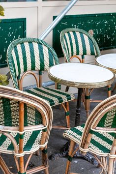 four wicker chairs and two tables outside