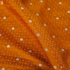 an orange fabric with white dots on it