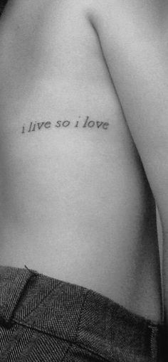 a person with a tattoo on their chest saying i live so i love you in cursive writing