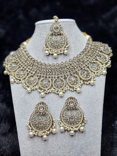 beautiful polki necklace sets with chandbali style Earrings and Tikka.   colors available in  ✨️gold white  ✨️Teal Party Pearl Drop Chandbali Necklaces, Silver Kundan Necklace With Pearl Drop, Party Bridal Chandbali Necklace With Pearl Drop, Party Bridal Necklace With Pearl Drop Chandbali, Silver Bollywood Necklace With Pearl Drop, White Chandbali Jewelry Sets For Eid, White Chandbali Pearl Necklace For Party, Diwali Bridal Necklace With Pearl Drop In Silver, Silver Bridal Necklace With Pearl Drop For Diwali