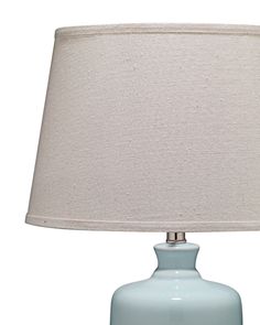 a light blue table lamp with a white shade on the top and bottom part of it