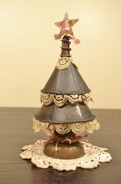 a small metal christmas tree sitting on top of a wooden table