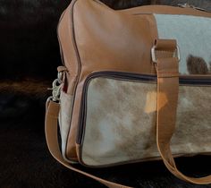 Travel Beige Satchel With Leather Backing, Beige Leather Travel Satchel, Beige Leather Satchel For Travel, White Leather Travel Duffle Bag, White Leather Duffle Bag For Travel, Beige Leather Shoulder Bag With Luggage Sleeve, Beige Leather Satchel Travel Bag, Beige Leather Satchel With Luggage Sleeve, White Leather Rectangular Weekender Bag