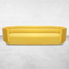 a yellow couch sitting on top of a cement floor