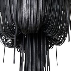 a sculpture made out of black leather with fringes