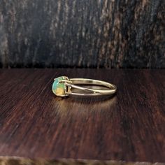 This lovely opal has all the colors of the rainbow. This glowing oval ring is perfect for the modern bride or that special someone in your life! This opal ring also makes a beautiful October birthstone gift for your loved ones! This ring is made with solid 14K Gold. Classic Opal Birthstone Ring With Round Band, Adjustable 14k Gold Oval Opal Ring, Adjustable Oval Opal Ring In 14k Gold, Adjustable 14k Gold Opal Ring, Classic Ethiopian Opal Gemstone Rings, Classic Round Cut Opal Birthstone Ring, Yellow Gold Oval Opal Promise Ring, Yellow Gold Oval Solitaire Opal Ring, Ethiopian Opal Oval Ring For Wedding