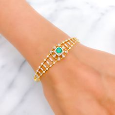 This exquisite 22k gold bangle bracelet, weighing 13.9 grams, features a stunning viridescent design adorned with dazzling diamonds and a cultured emerald. The yellow gold finish enhances its luxurious appeal, making it perfect for any special occasion. The bangle is set with 0.87 carats of F-G color, VS quality diamonds in round brilliant cut shapes and features an oval-shaped cultured emerald. With an oval opening of 2.3 inches, this piece offers both elegance and comfort. The bangle is openab Green Diamond Bangle Bracelet For Formal Occasions, Formal Green Diamond Bangle Bracelet, Green Bangle For Formal Occasions, Fine Jewelry Style, Green Diamond Bangle As A Gift, Yellow Gold Emerald Bracelets For Wedding, Green Diamond Bangle As Gift, Green Diamond Bangle For Gift, Elegant Gold Bangle With Emerald, Formal Emerald Bangle