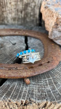 a ring sitting on top of a piece of wood