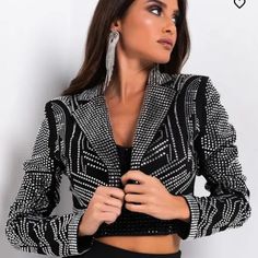 A Gorgeous Beautiful Rhinestone Crop Style Jacket Embellishments Cover The Entire Jacket Make It A Statement All By Itself It Has One Button For Closure Which Looks So Good Open Instead It Could Be Formal Wear Or Casual Wear With Jeans Or In Between A Unique Piece Definitely. Elegant Black Cropped Jacket, Elegant Evening Blazer With Rhinestones, Elegant Rhinestone Blazer For Party, Elegant Fitted Blazer With Rhinestones, Elegant Party Blazer With Rhinestones, Chic Embellished Long Sleeve Blazer, Luxury Fitted Cropped Jacket For Party, Elegant Long Sleeve Cropped Jacket For Night Out, Elegant Long-sleeved Blazer With Rhinestones