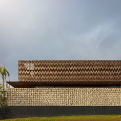 a building that has a roof made out of wavy tiles on the side of it