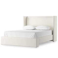 a white bed with two pillows on top of it