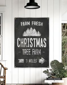 a christmas tree farm sign hanging on the wall