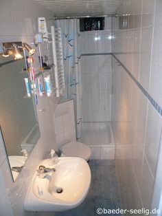 a bathroom with a sink, mirror and shower stall