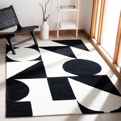 a black and white area rug with circles on it in front of an open window