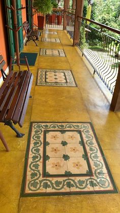 the walkway is lined with benches and potted plants on either side of the porch