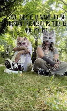 two people sitting in the grass with masks on