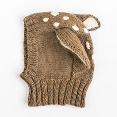 a brown knitted mitt with white polka dots on the side and an elephant head