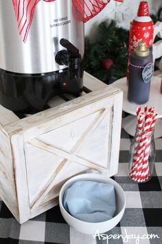 a table topped with an ice cream maker and christmas decorations