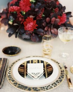 a table setting with place settings and flowers