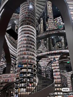 a spiral staircase in a library filled with books