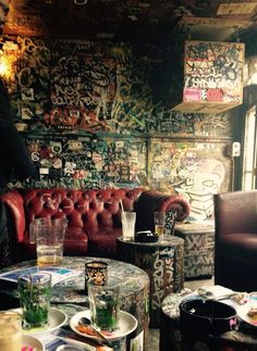 a living room filled with furniture covered in graffiti