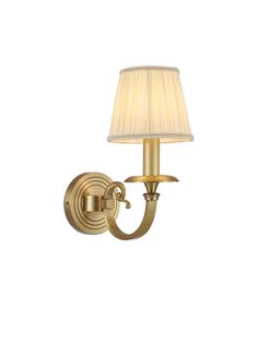 a gold wall light with a white shade on the top and bottom half of it