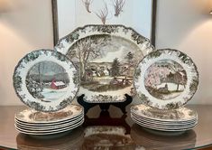 a table topped with lots of plates on top of a glass shelf