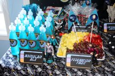 a table topped with lots of different types of fruits and drinks on top of it