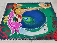 a colorful painting on the ground with an instrument