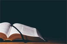 an open book sitting on top of a wooden table