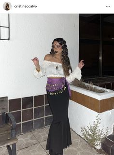 a woman in a costume standing next to a bath tub with her hands out and pointing at the camera