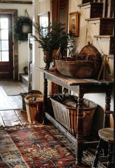 a room filled with lots of baskets on top of a wooden table next to a doorway