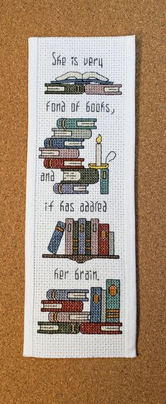 a cross stitch bookmark with some books on it