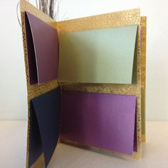 an open card with purple, green and yellow cards