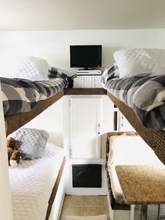 two bunk beds in a small room with white walls