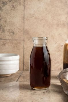 a jar of honey sitting on top of a counter