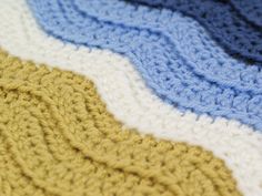 there is a crocheted blanket that looks like it has been made with yarn